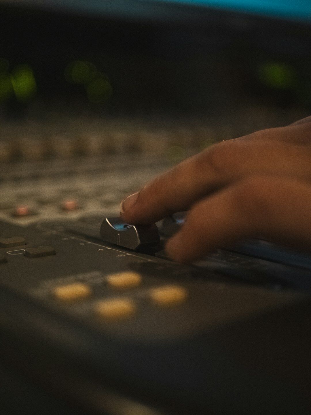 Close up of hands operating a video vision mixer panel